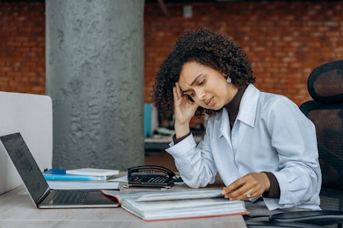 Free An Exhausted Woman Reading Documents Stock Photo