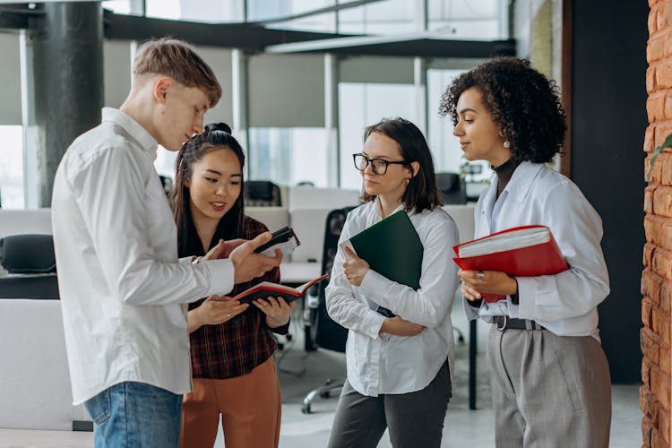 A Group Of Employees Talking 