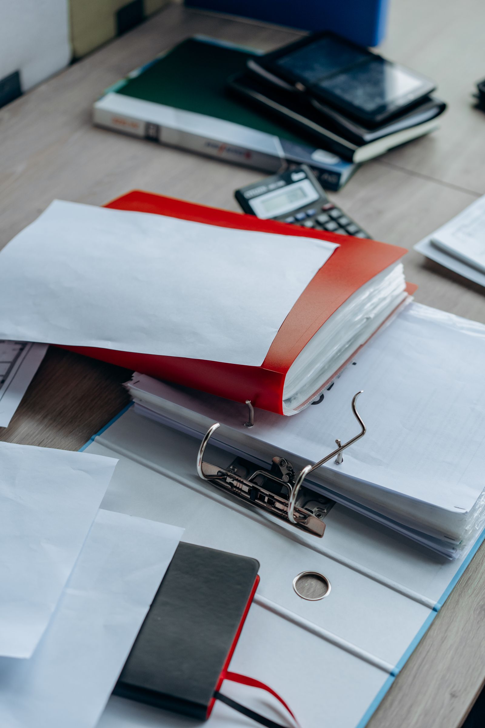 A tidy desk with binders, papers, and office supplies