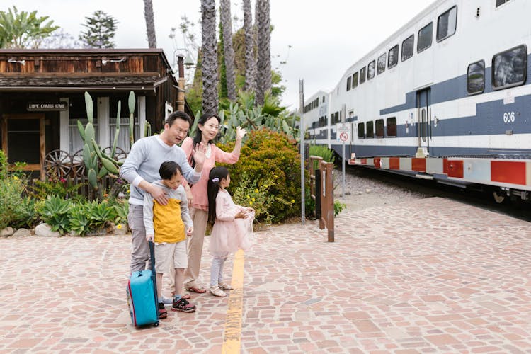 An Asia Family Waving Towards The Train