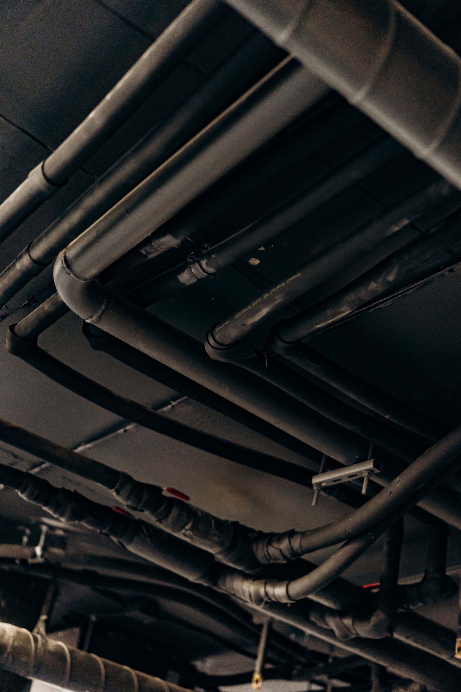 What a TAB report includes — insulated hydronic piping above a commercial mechanical ceiling