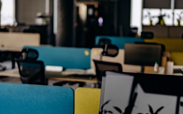Open office space with computers and colorful partitions, perfect for modern work settings.