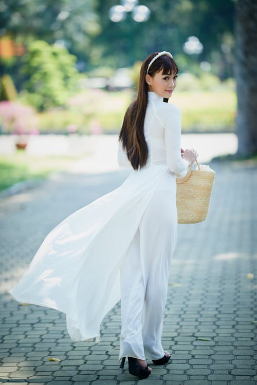Woman in White Long Sleeve Dress Looking Back