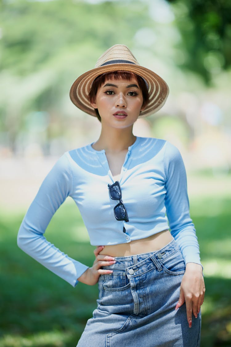 A Woman In Blue Long Sleeves Wearing A Hat