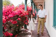 Grandfather and Granddaughter Holding Each Others Hand while Smiling at the Camera