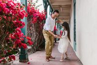 Granddaughter and Grandfather Dancing on the Hallway Near Bougainvillea Flowers