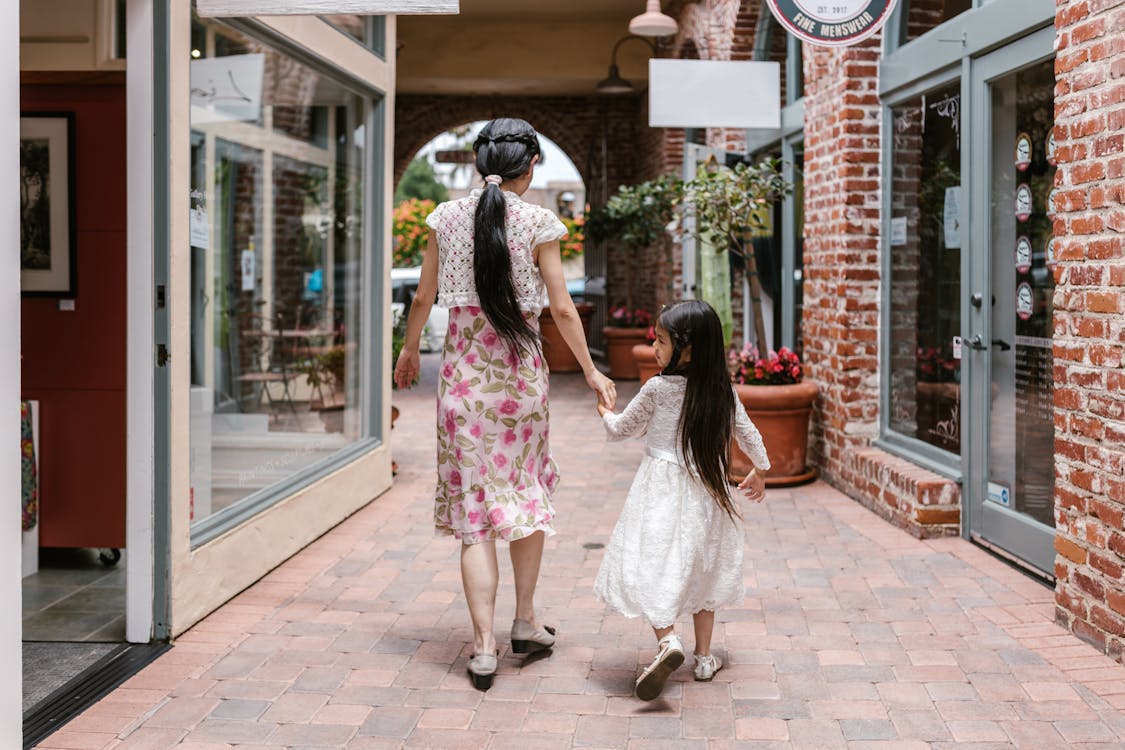 2 Women Walking on Sidewalk