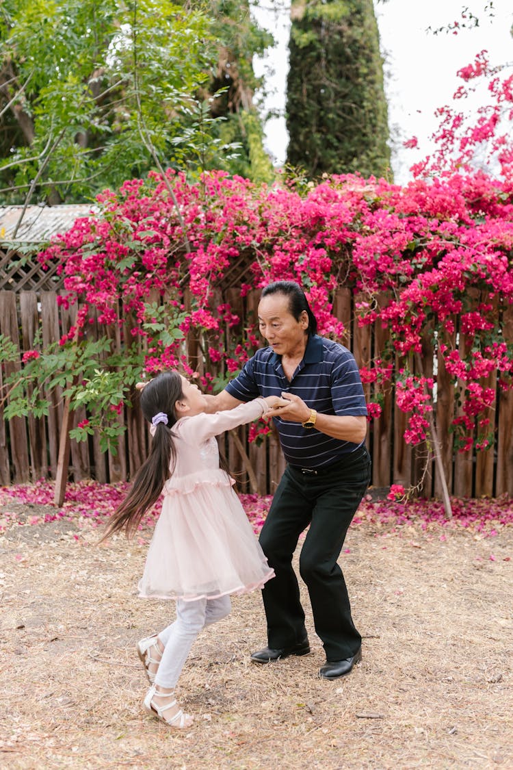 A Grandfather Dancing With His Granddaughter