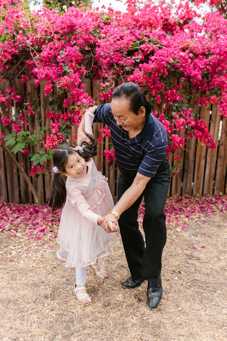 A Grandfather Dancing With His Granddaughter