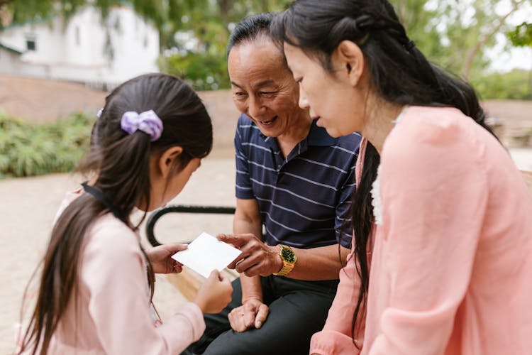 Family Looking At The Card Together