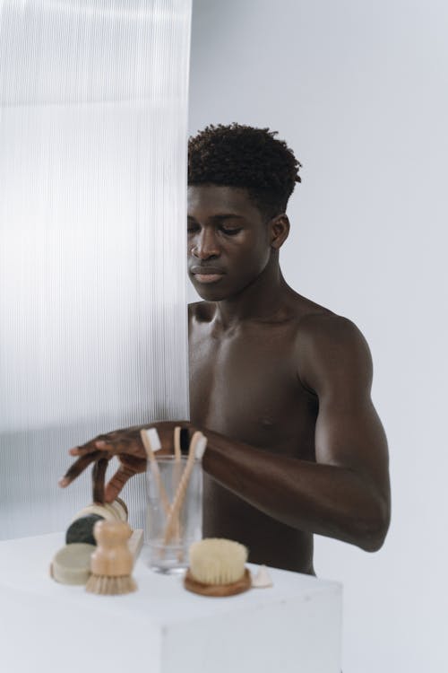 Free Shirtless Young Man Holding a Shower Brush Stock Photo