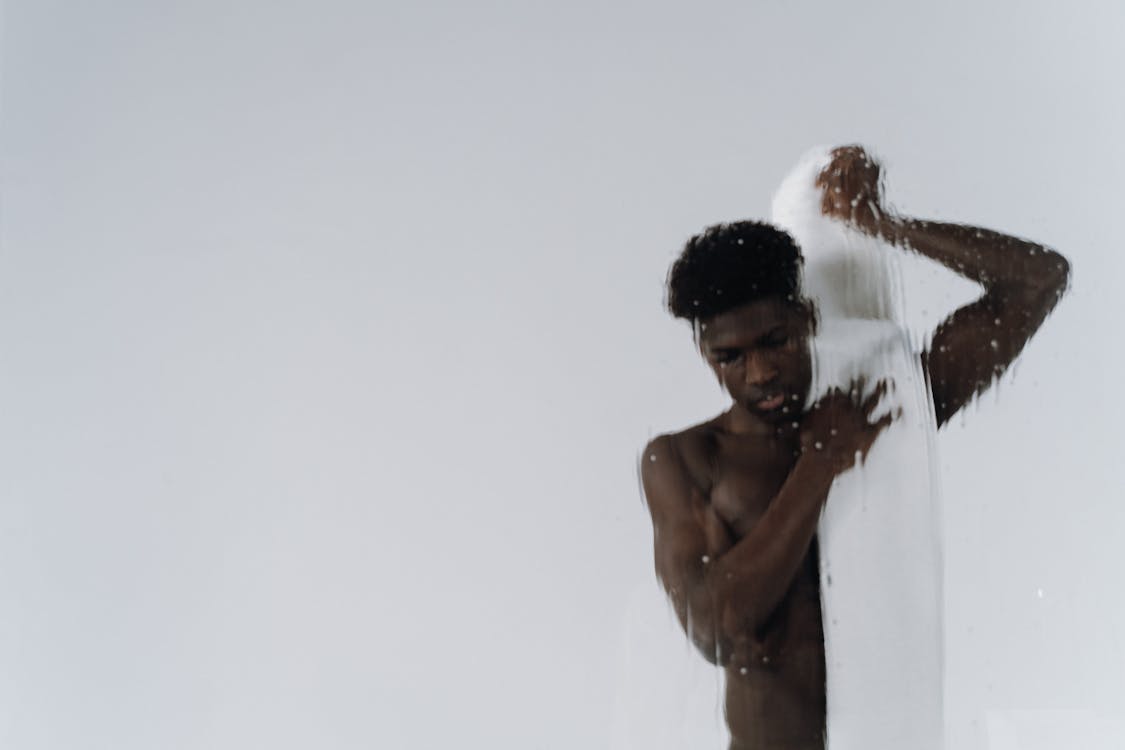 Free Shirtless Man Putting Towel on his Shoulder  Stock Photo