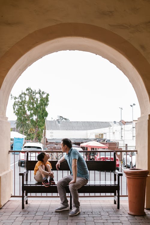 People Sitting on Chair Near Building