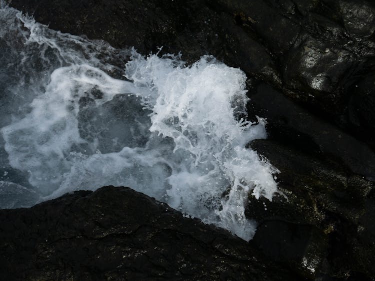 Close Up Of Wave Among Rocks