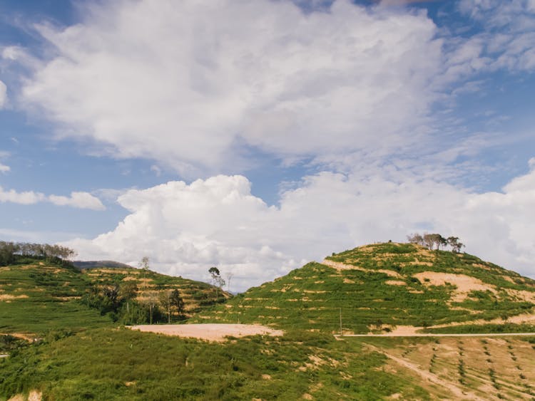 Green Hills Under Cloudy Sky 