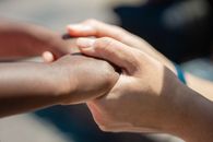 Persons Hand on Persons Hand