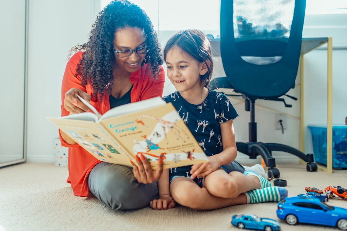 Mother and child reading together during a calm home learning moment