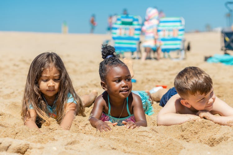 Kids Lying On Sand