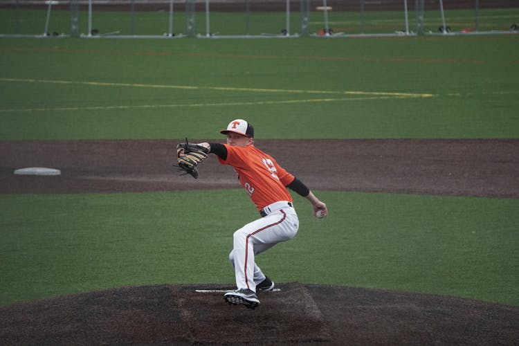 Man Throwing The Ball In Baseball 