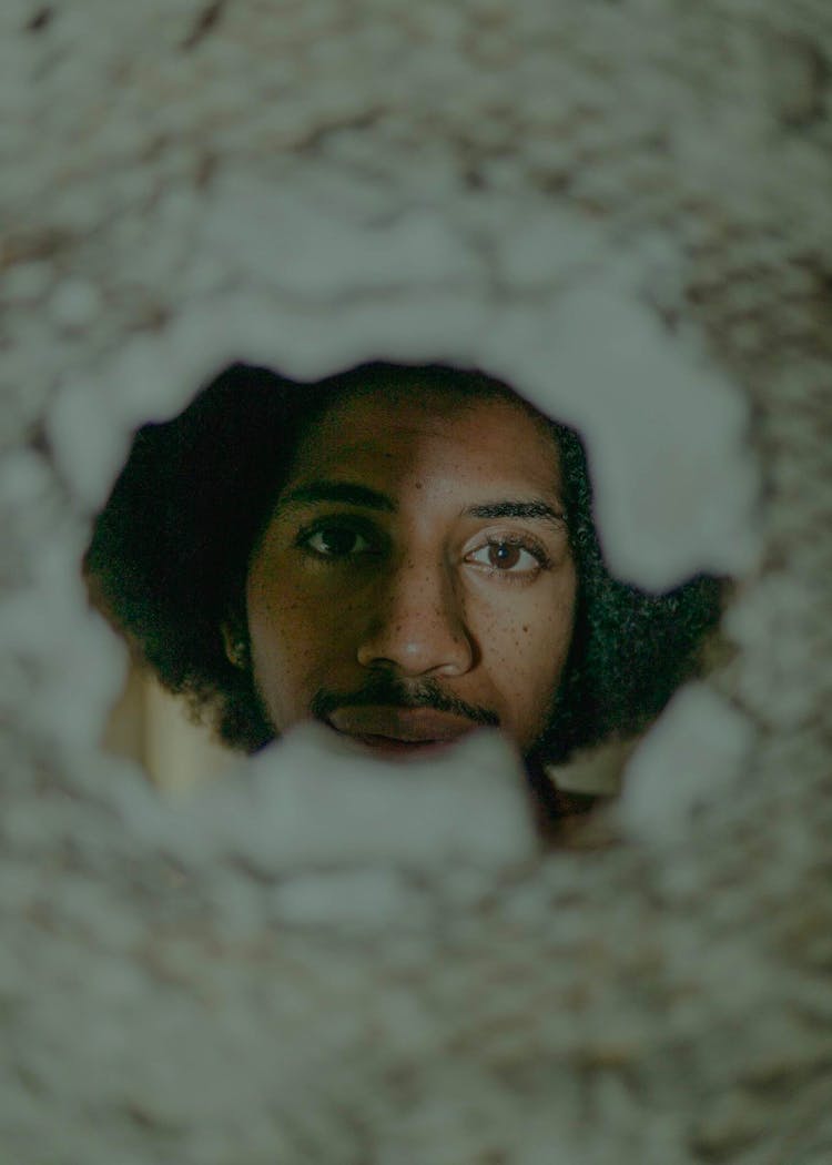 Portrait Of A Man Through A Hole In A Wall 