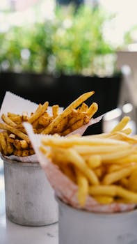 Appetizing crispy French fries served in rustic containers, perfect for fast food lovers.