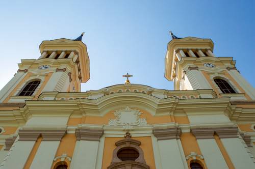 Free Majestic church facade under a clear blue sky, capturing historical architecture from a low angle. Stock Photo