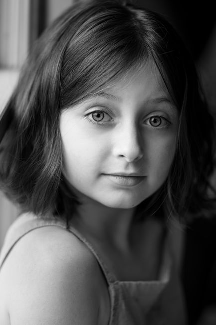 Expressive monochrome portrait of a child with soft lighting.