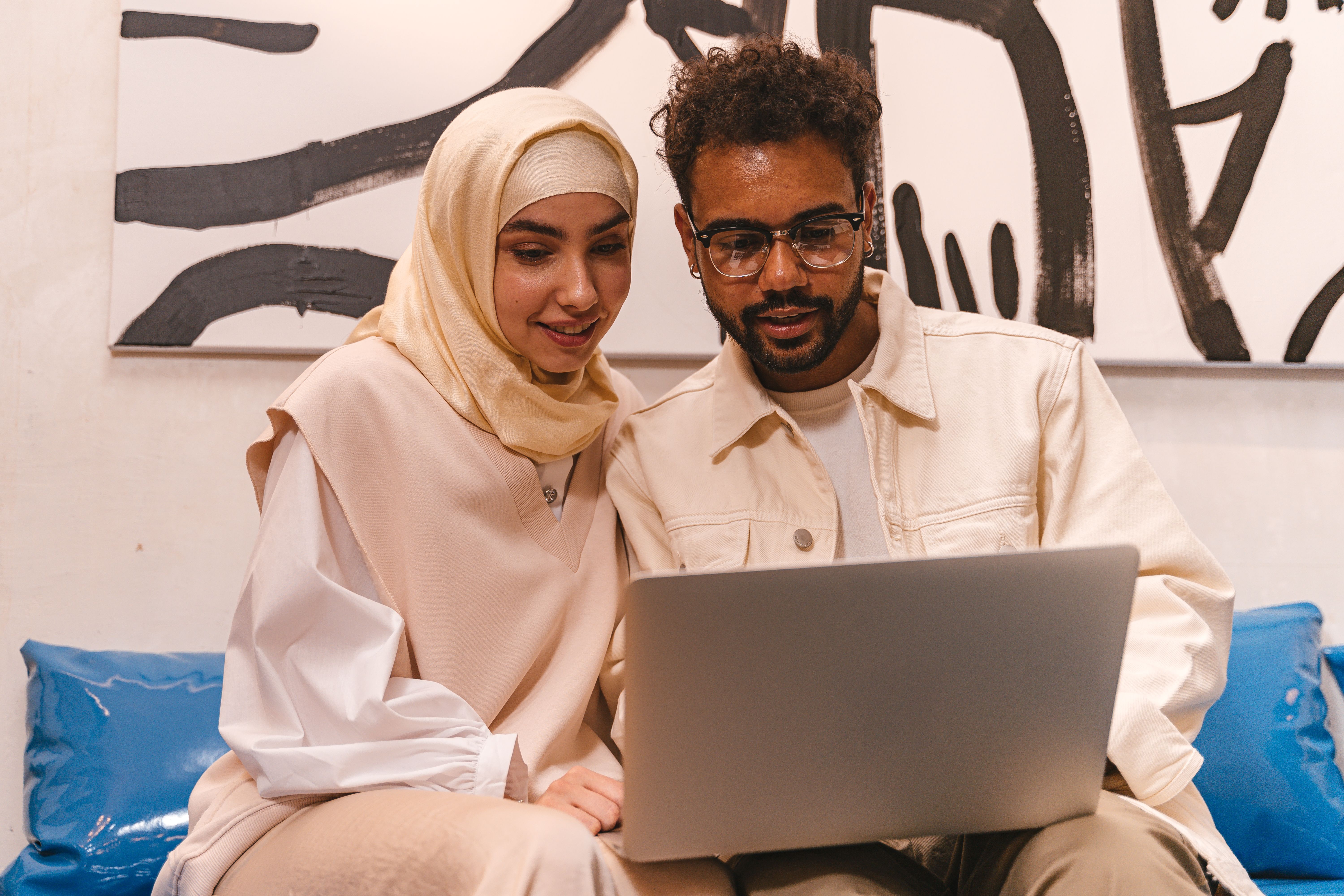 Diverse couple using a laptop to compare mortgage rates, with Tampa city map in the background