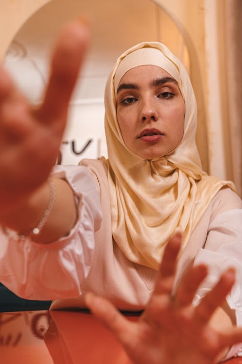 Free Portrait of a Woman with a Hijab Reaching Stock Photo