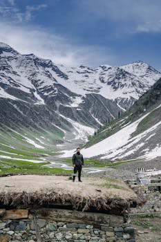 Man posing in front of scenic snow-capped mountains at Forest Block.