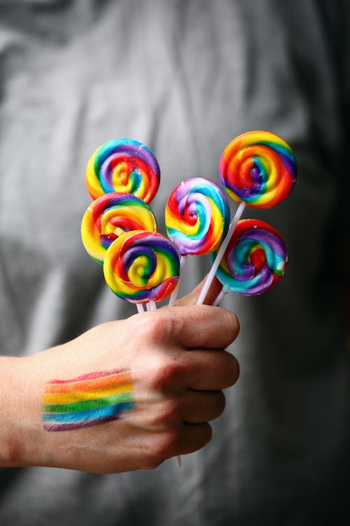 A Person Holding a Colorful Lollipops