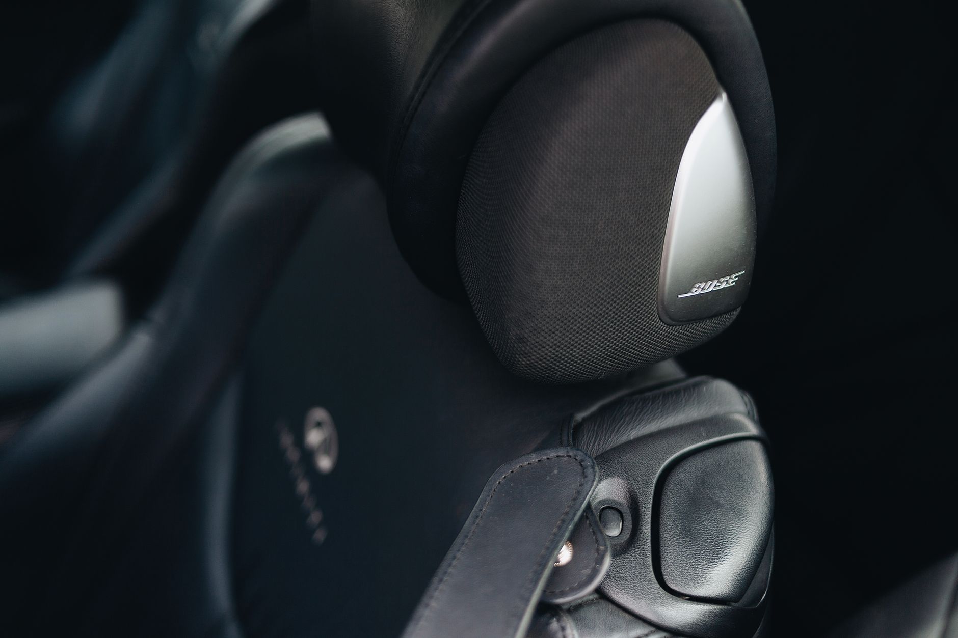 Close-up of luxury car interior showing Bose speaker and premium leather seating in Baltimore.