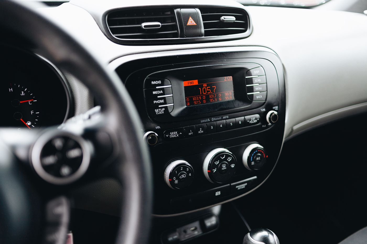 Car dashboard with the heater and climate control knobs below the radio