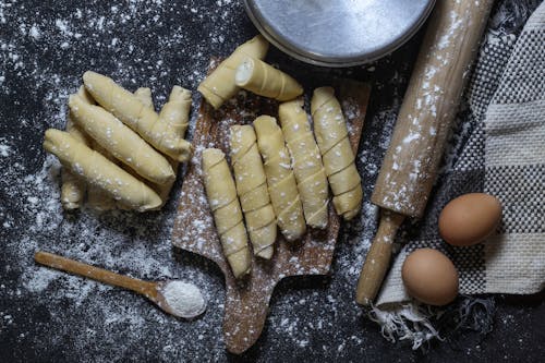 Homemade Pastry on Wooden Board and Baking Utensils