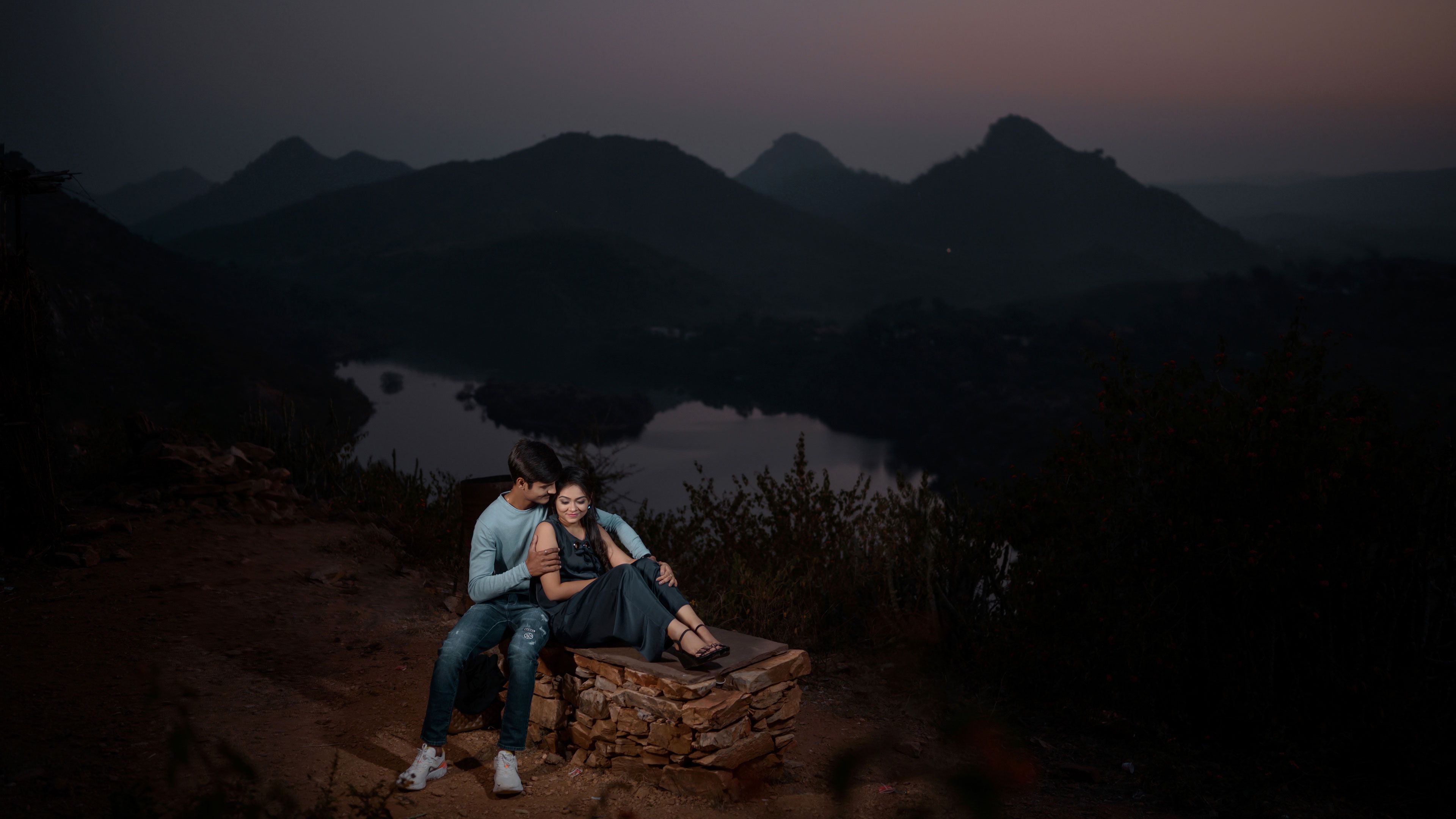 Man Hugging Woman While Sitting on Brown Rock Near Lake at Dawn · Free ...