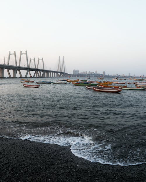 Orange Boats in the Sea Near Bridge