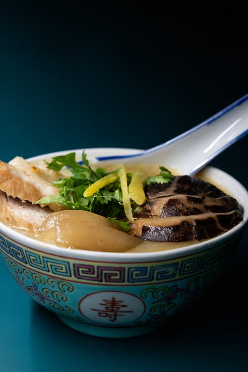 Asian Food in Blue Ceramic Bowl with Spoon