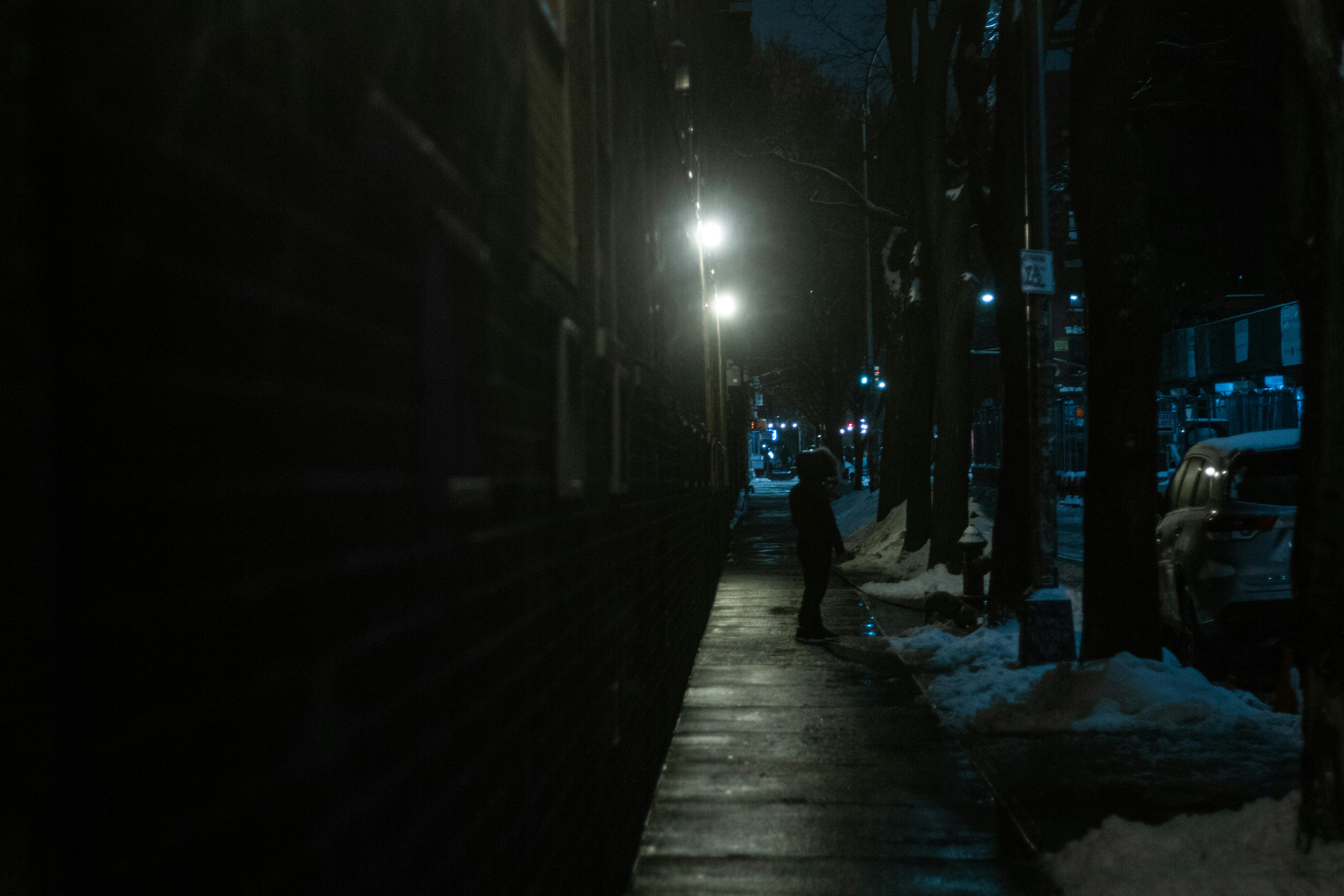 Silhouette of person with umbrella on street · Free Stock Photo