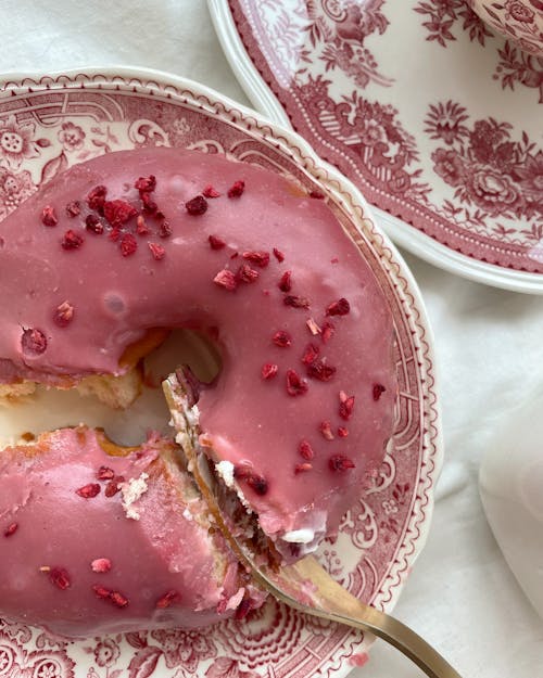 Close-Up Shot of a Pink Doughnut on a Plate