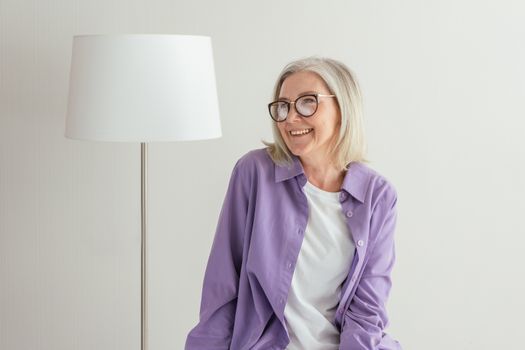 A Woman in Purple Long Sleeves Smiling while Wearing Eyeglasses