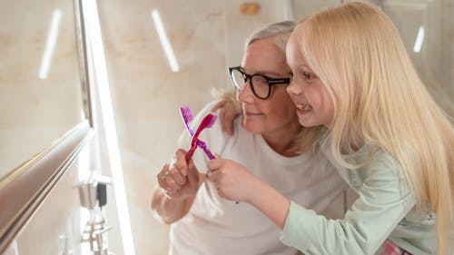 Woman in White Crew Neck T-shirt Wearing Black Framed Eyeglasses