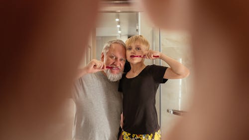 Free Boy Brushing his Teeth with his Grandfather Stock Photo