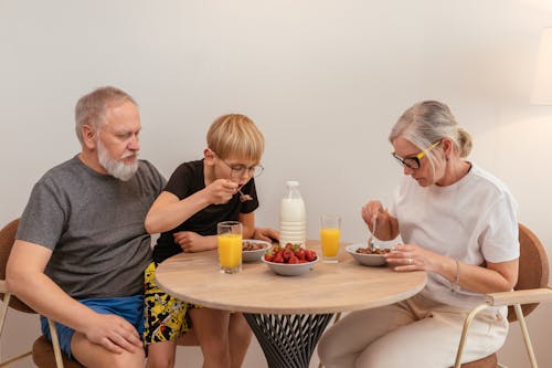 Free Grandparents Eating Breakfast with their Grandson Stock Photo