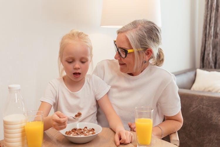 Pensioner Grandmother Sitting With Her Granddaughter