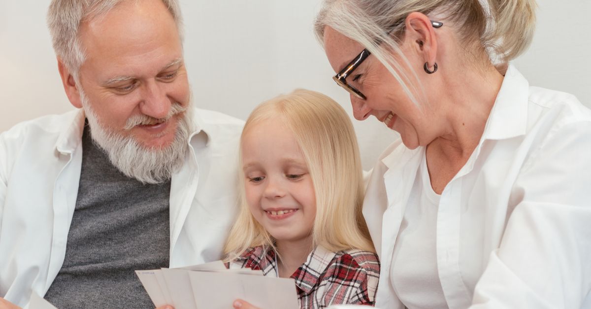 Joyful family gathering, grandparents sharing memories with granddaughter, highlighting love and connection.