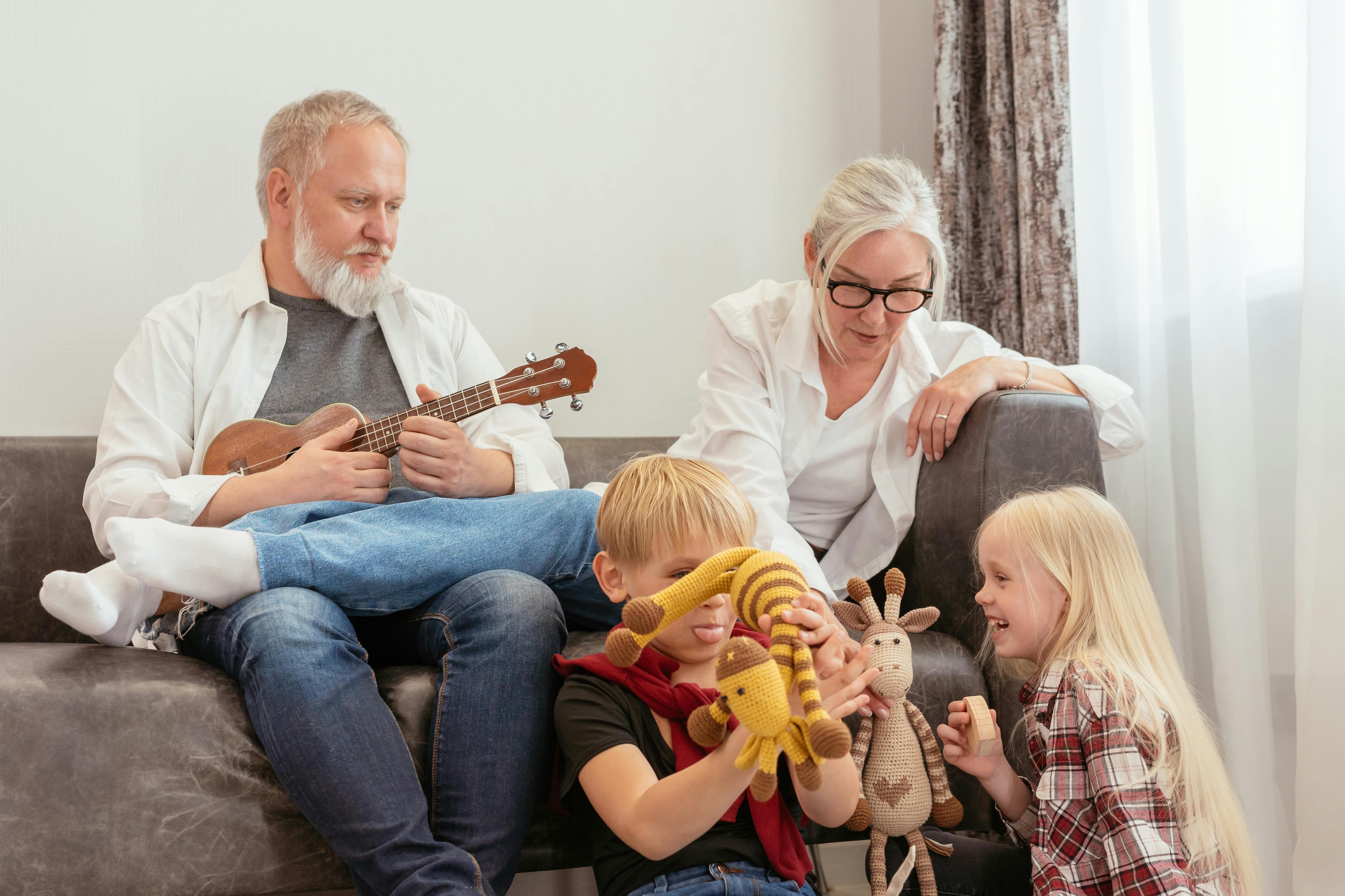 grandparents playing with children in the living room