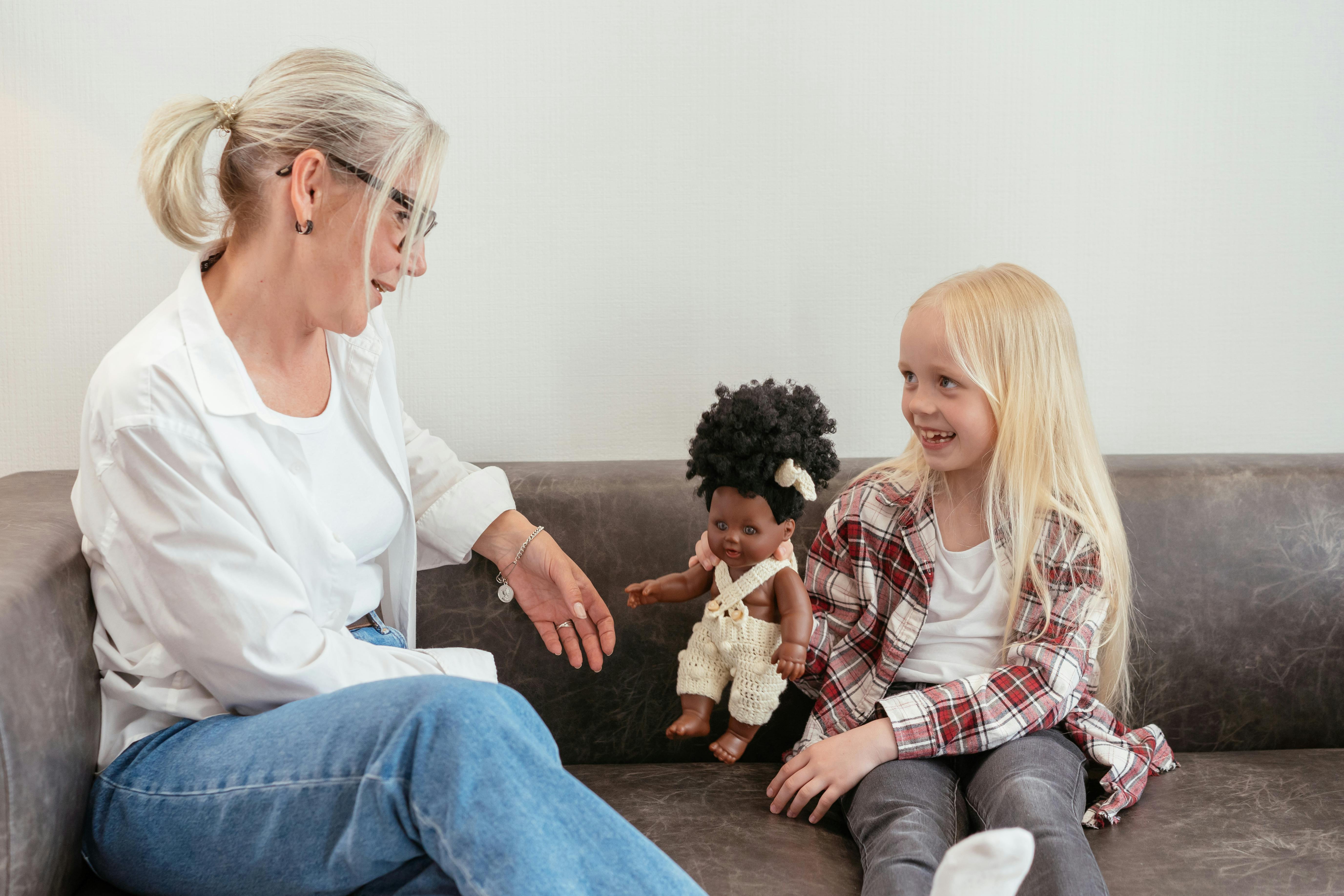 elderly woman sitting on sofa with a girl