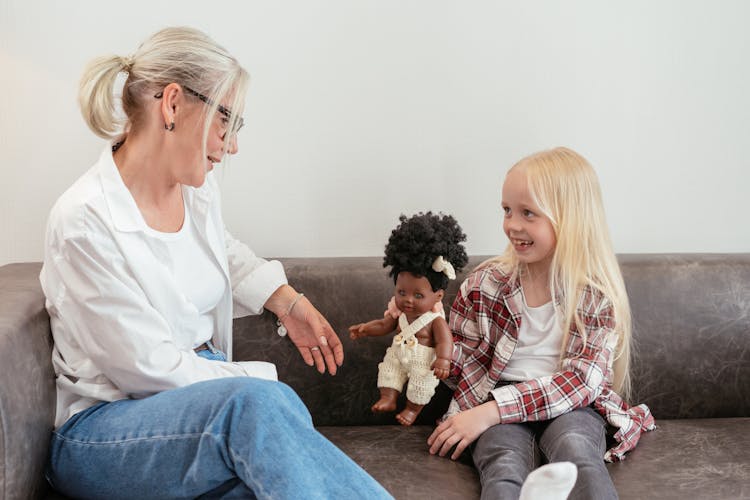 Elderly Woman Sitting On Sofa With A Girl