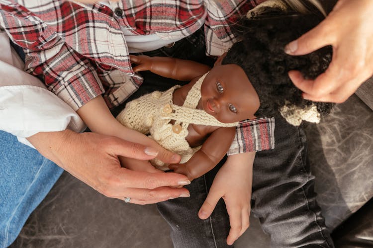 A Girl Playing With A Doll