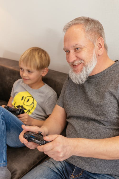 A Man Playing a Video Game with his Grandson
